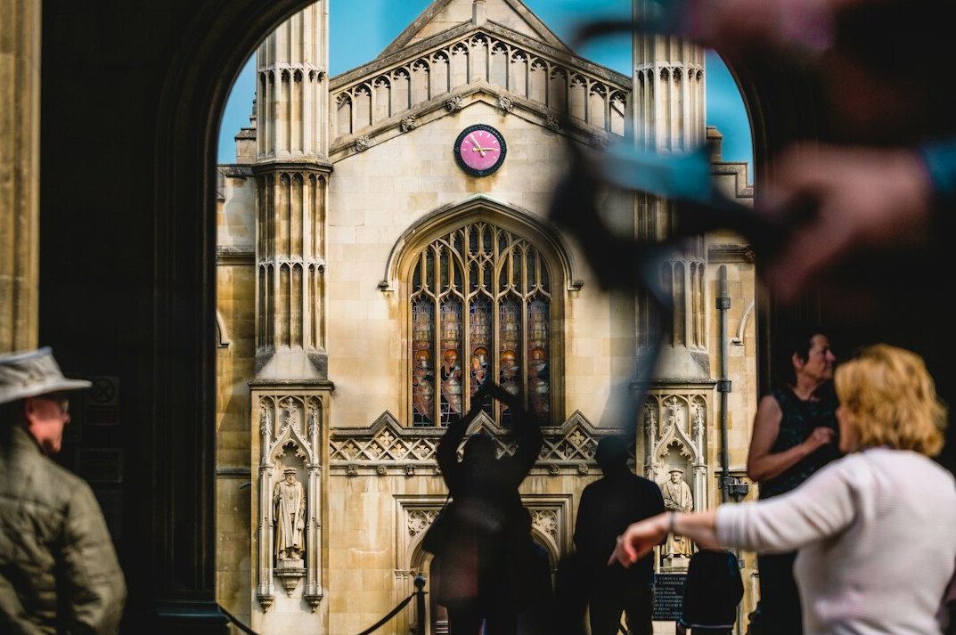 Camera operator filming an outdoor news broadcast in the UK